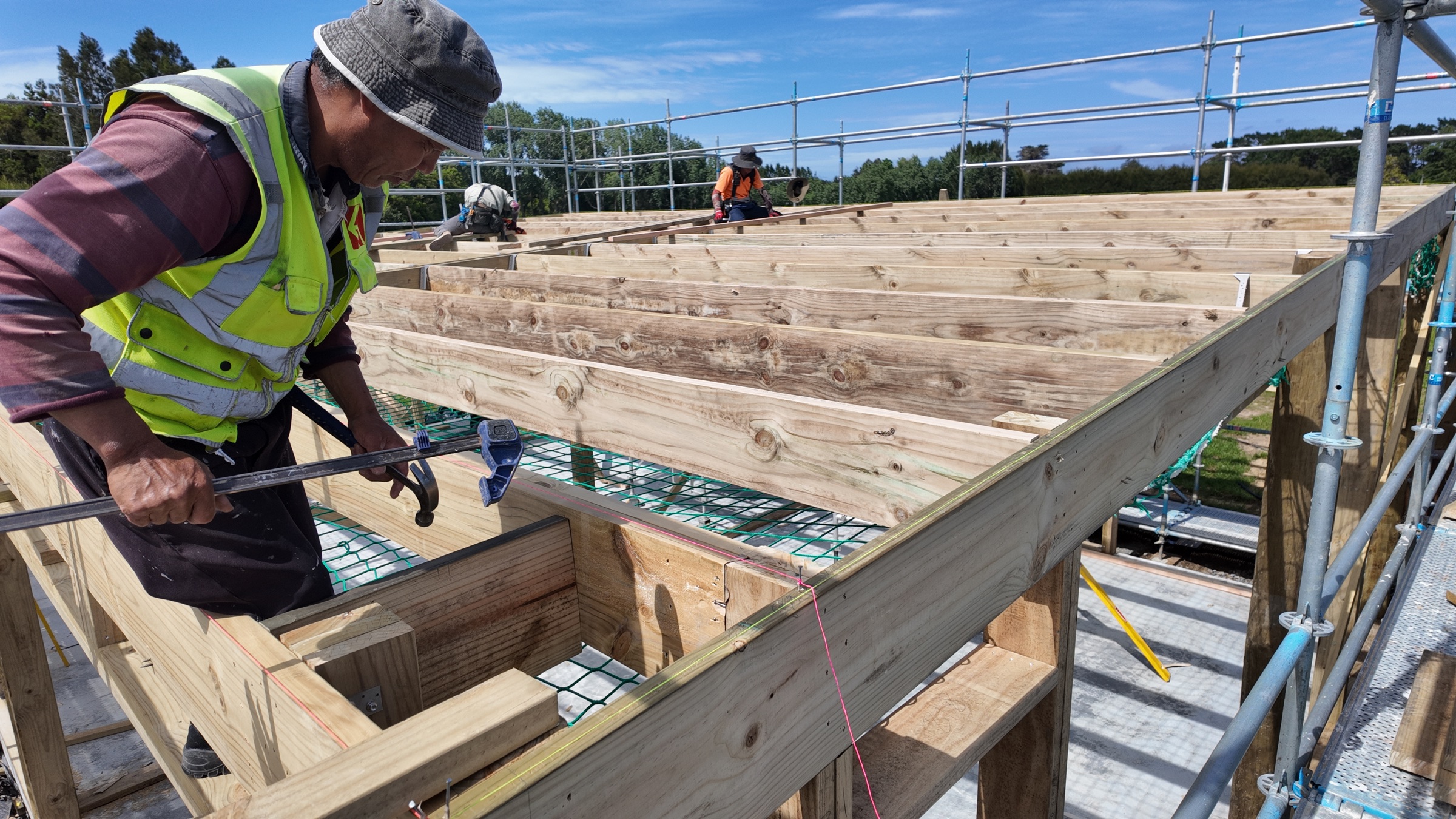 Carpenters assembling the garage roof framing
