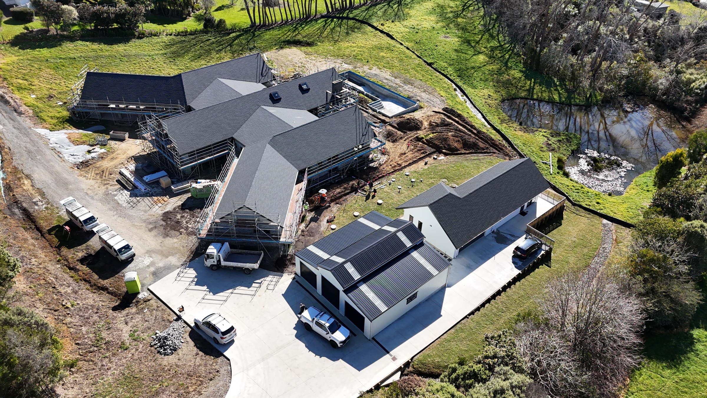 Aerial view showing the new home, pool and rural setting