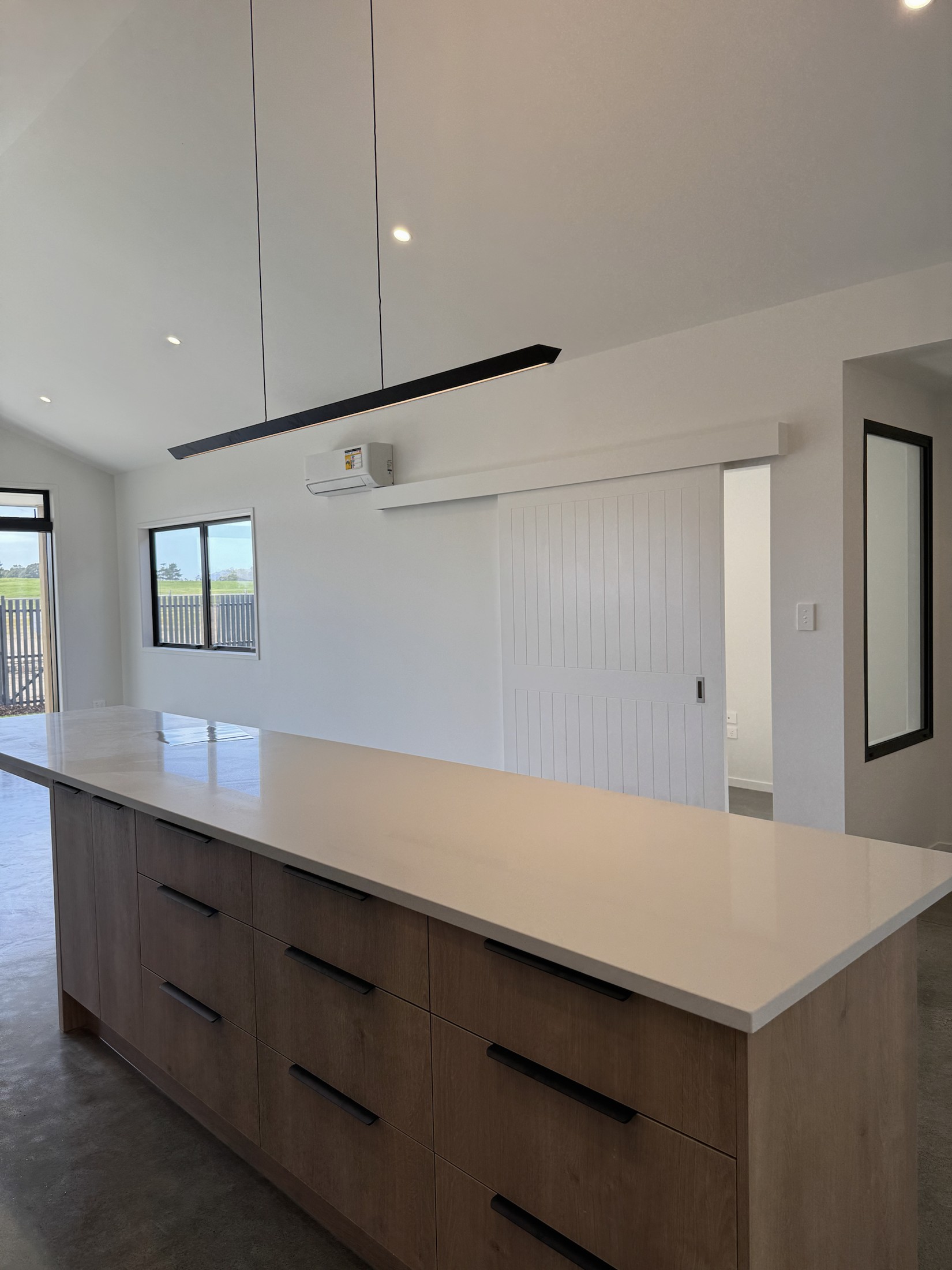 White stone kitchen island with timber-fronted drawers