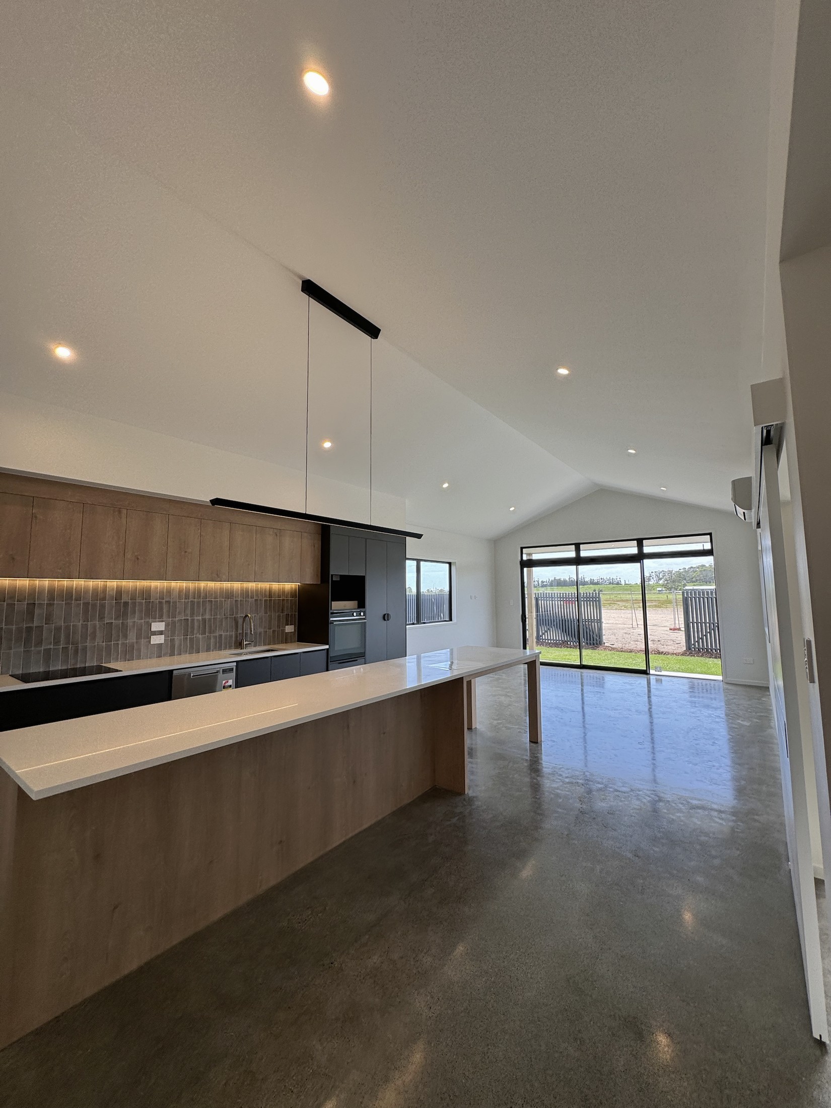 Long view through the kitchen to the glazed living area
