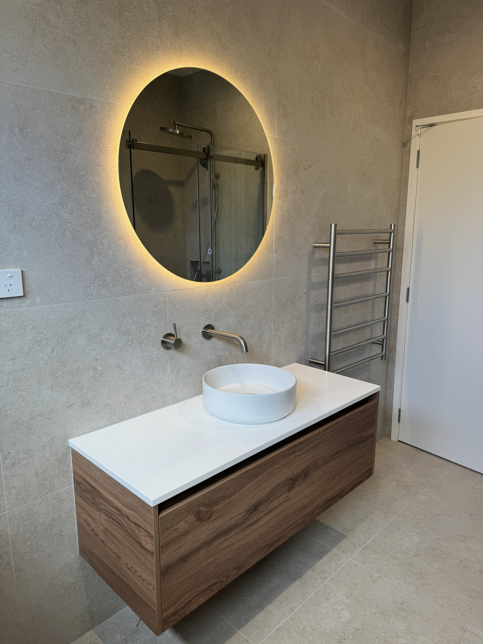 Southern Oak wall-hung vanity with matt-white basin and back-lit mirror