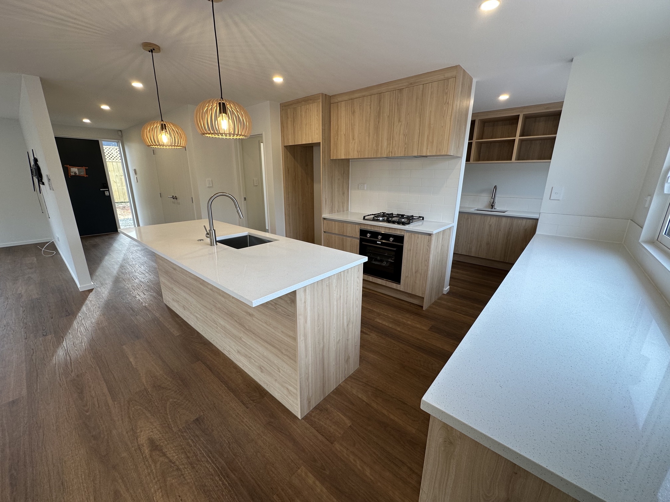 Completed timber-look kitchen with white stone benchtops