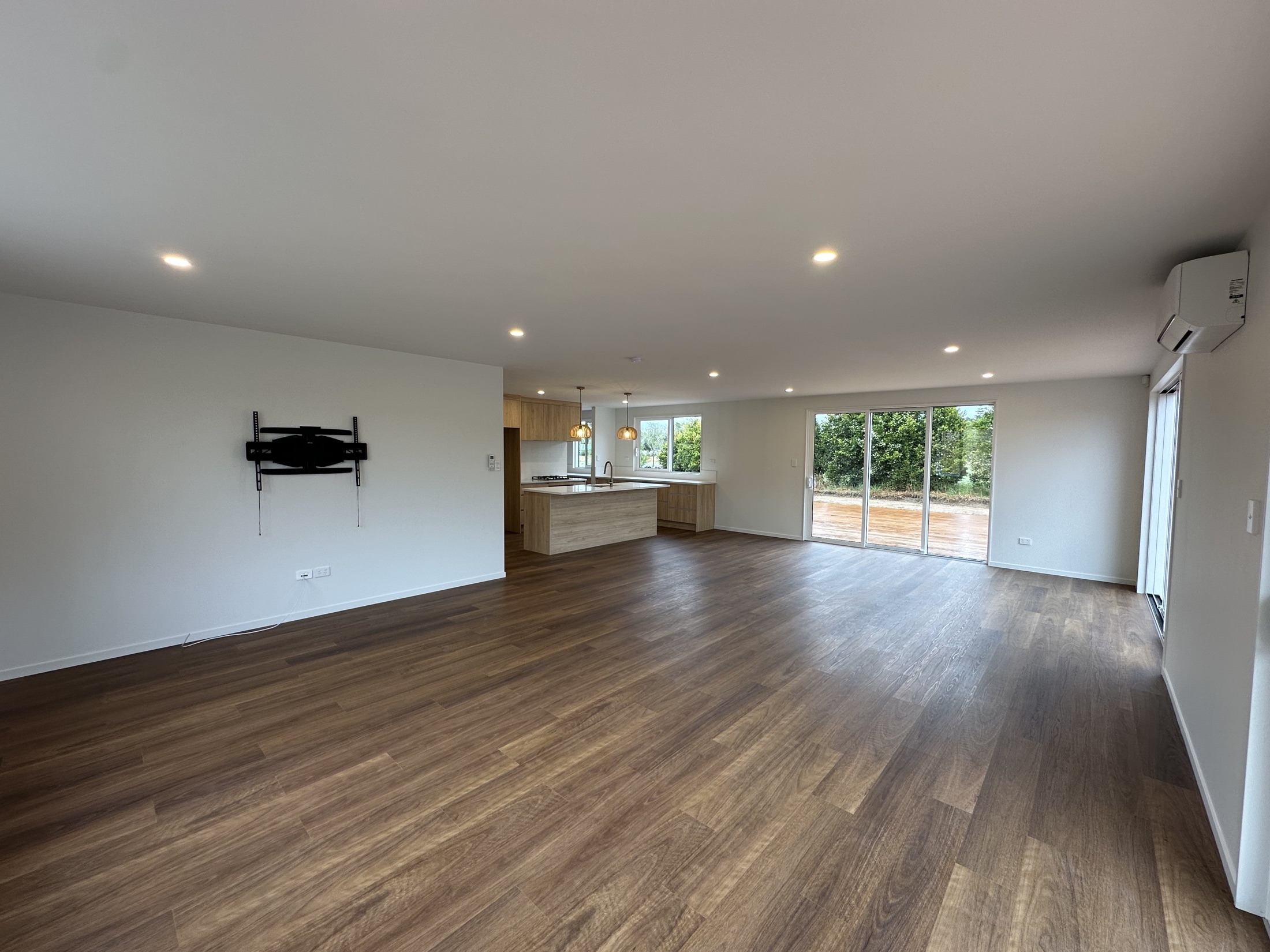 Open-plan living and dining area with timber-look flooring