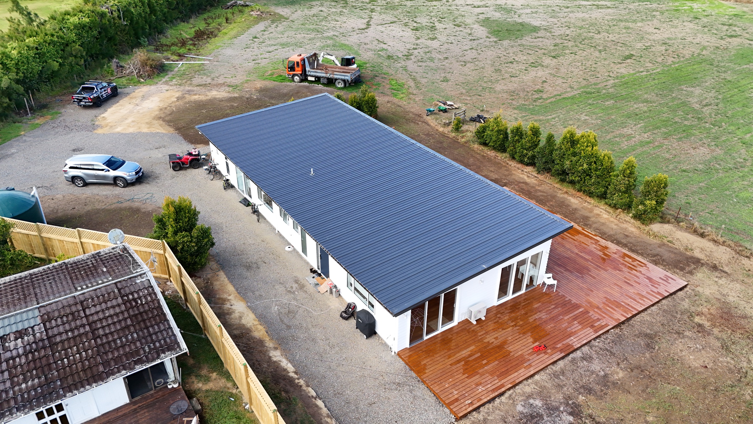 Close aerial overview of the new home and deck