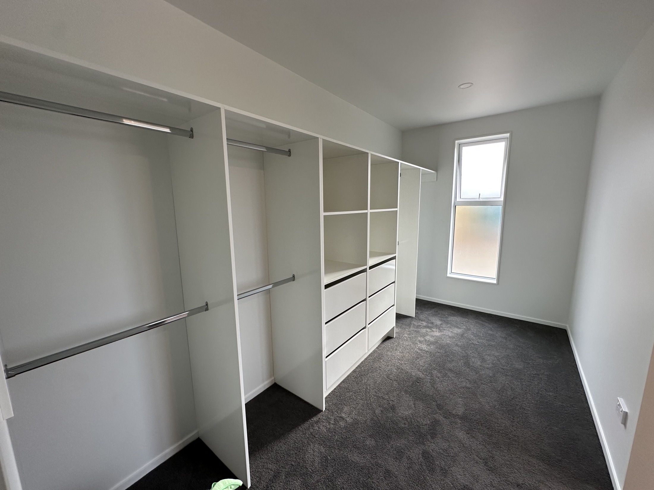 Walk-in wardrobe with fitted shelving, drawers and hanging rails
