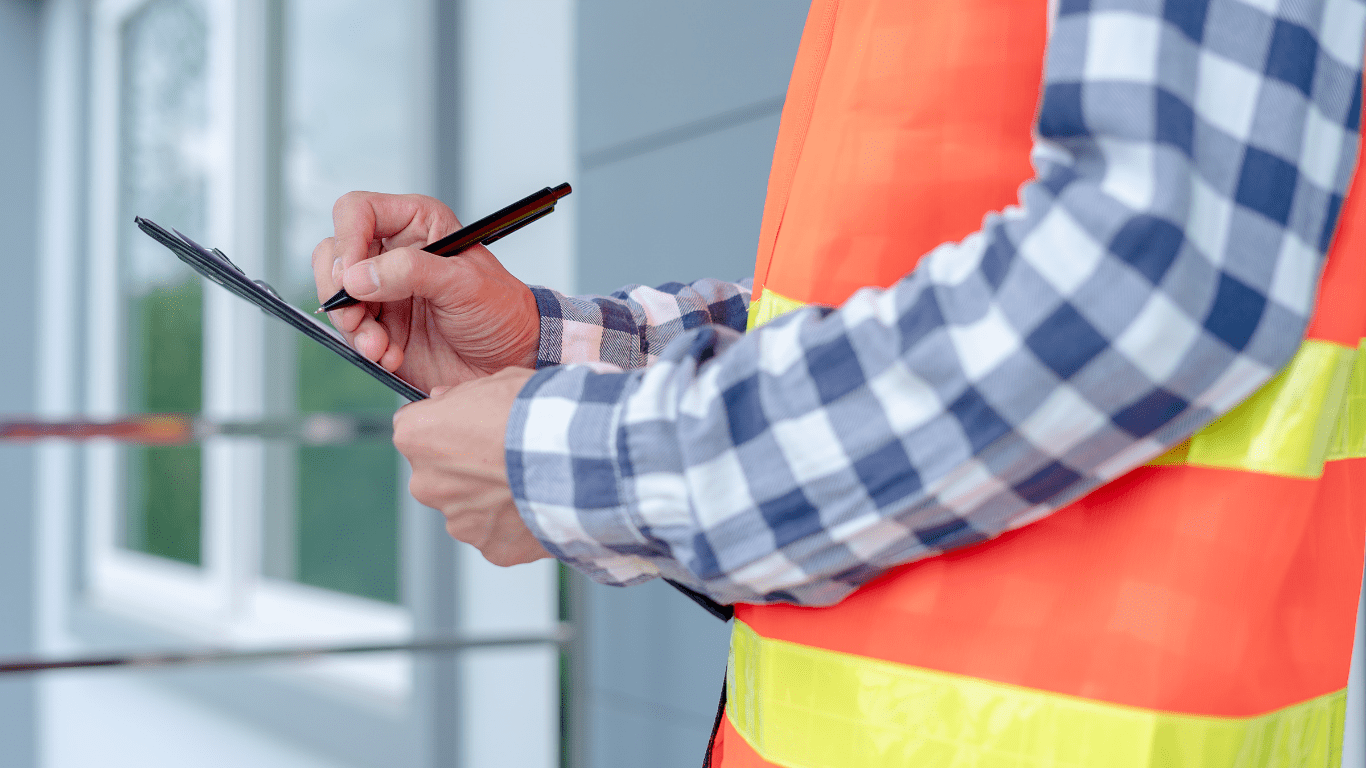 Engineer holding his notes and his pen.